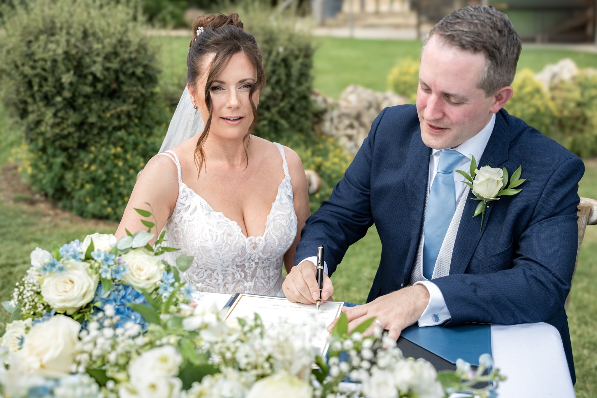 Bride and groom signing the marriage register at Notley Tythe Barn