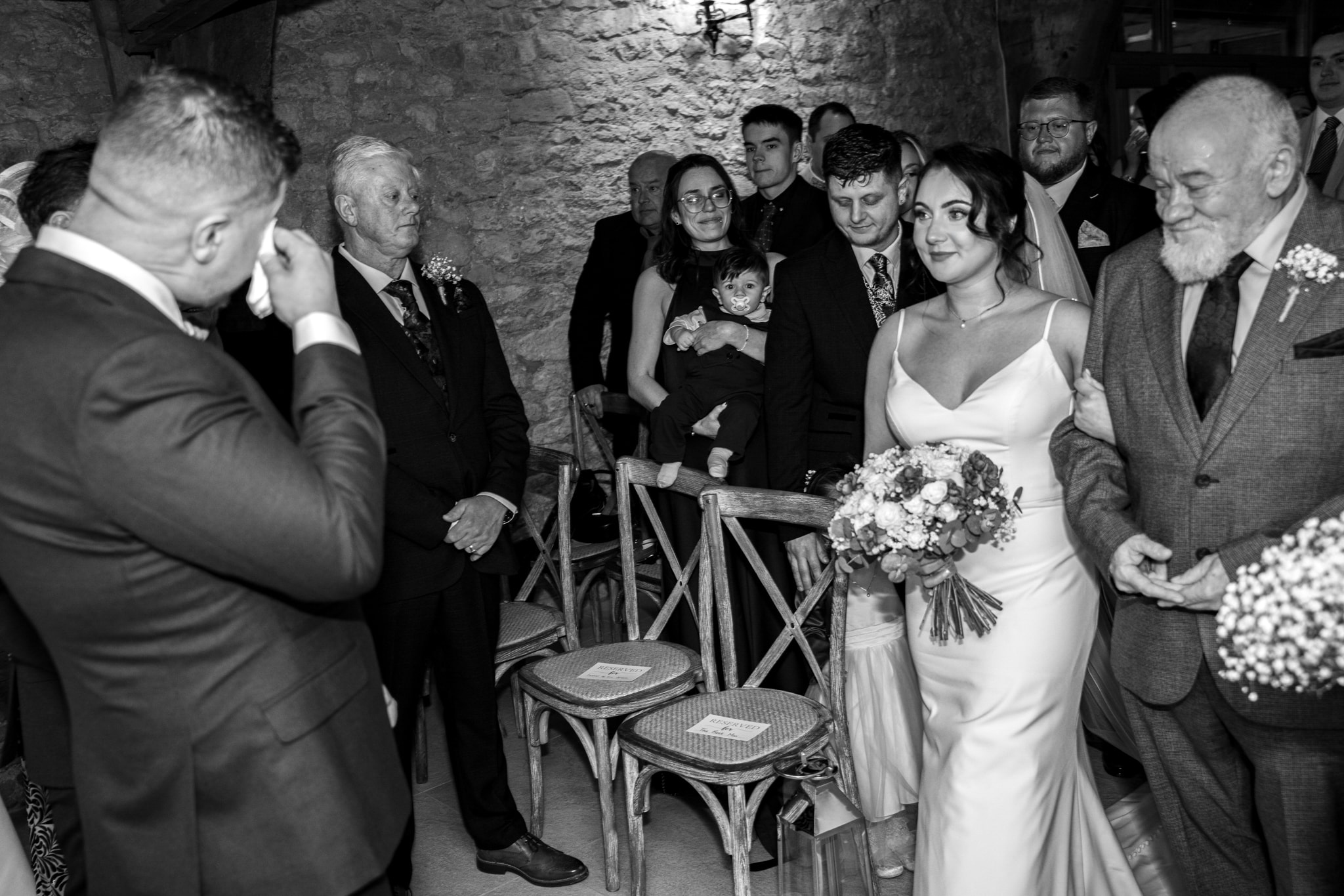Black and white — groom emotional as bride walks down the aisle at Notley Tythe Barn
