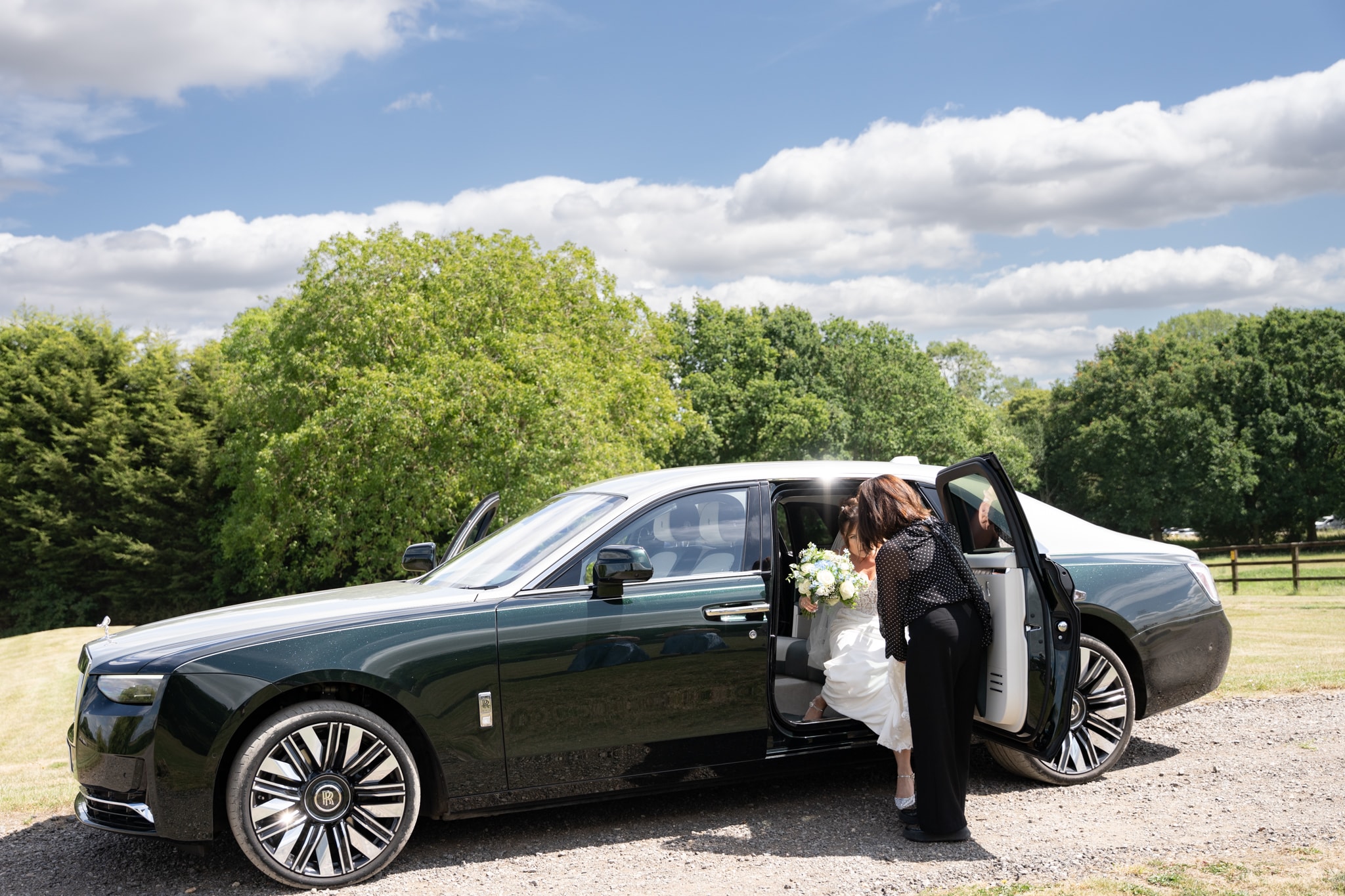 Bride arriving by luxury car at Notley Tythe Barn wedding